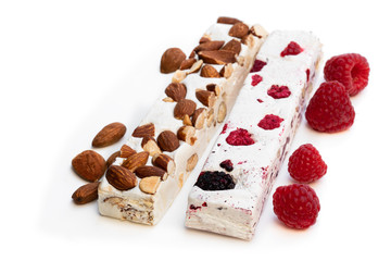Homemade nougat bars with almonds and dried fruits isolated on white