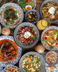 A variety of dishes on a wooden table. Restaurant serving. Top view.