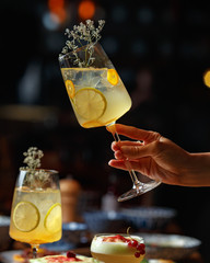 Alcoholic cocktail in a female hand on a dark background