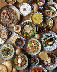 A variety of dishes on a wooden table. Restaurant serving. Top view.