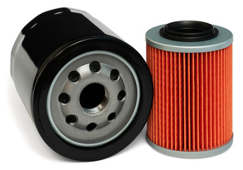 Isolated filters of motor oil. Insert orange and screw-on solid black filters of engine oil at white background.