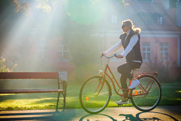 Fototapeta na wymiar Urban biking - woman riding bike in city park