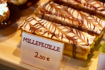 Freshly baked stuffed sweet Millefeuille pastries in traditinal French bakery in small village in Provence