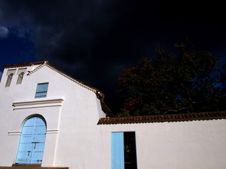Facade of an old colonial church at the colonial town of Villa de Leyva, in the Andean mountains of central Colombia, at sunset.