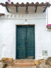 Old green door at a street of the colonial town of Villa de Leyva, in the Andean mountains of central Colombia.