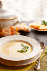 Creamy fish soup with salmon and potatoes on woodwn table