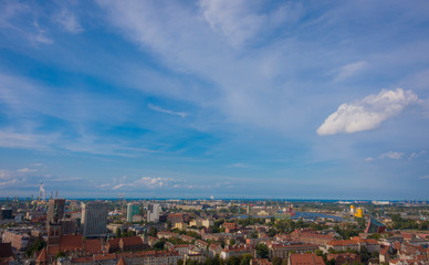 Fototapeta premium Panorama from the height of the city of Gdańsk, cityscape, cranes, smog, buildings, top-view, buildings, industrial, old town, clouds, urban, aerial, town, port