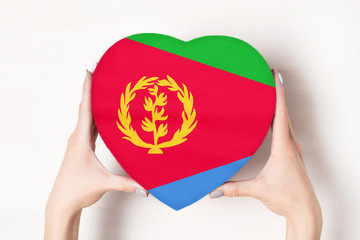 Flag of Eritrea on a heart shaped box in a female hands. White background