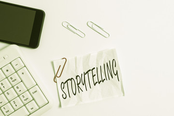 Text sign showing Storytelling. Business photo showcasing social and cultural Activity with Theatrical Gestures White pc keyboard with empty note paper above white background and mobile phone