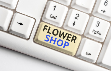 Text sign showing Flower Shop. Business photo showcasing where cut flowers are sold with decorations for gifts White pc keyboard with empty note paper above white background key copy space