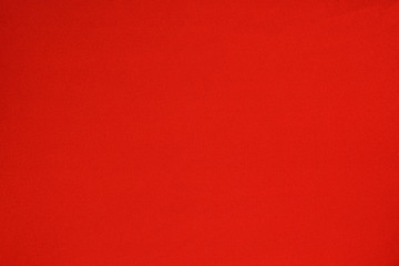 Smooth texture of bright red seamless fabric.