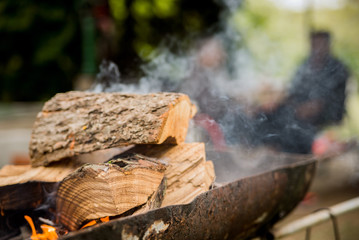 Flaming Empty Hot Barbecue Charcoal Grill With Glowing Coals On nature Background. Grill with smoke over summer outdoor nature in garden or park, outdoor, close up