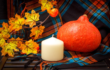 Autunm composition with pumpkin, candles and leaves. Concept autumn comfort