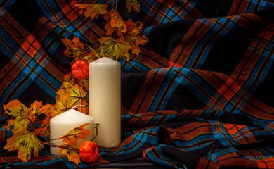 Autunm composition with pumpkin, candles and leaves. Concept autumn comfort