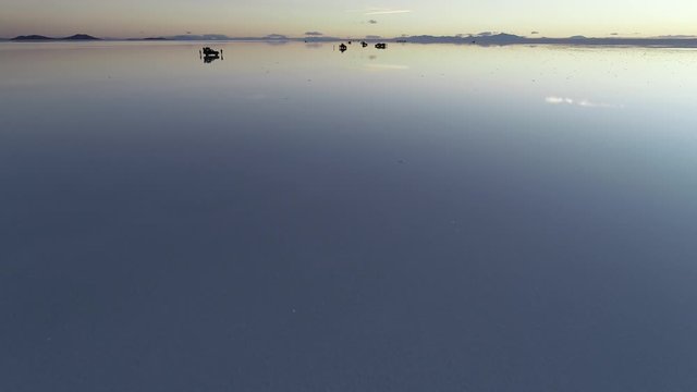 People photograping over water in Salar de Uyuni