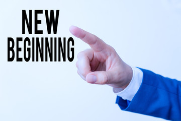 Writing note showing New Beginning. Business concept for Different Career or endeavor Starting again Startup Renew Isolated hand pointing with finger. Business concept pointing finger