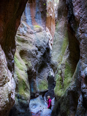 Bella mujer senderista dentro de gruta cueva natural de colores