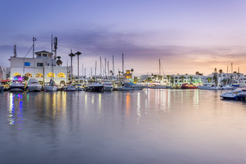 Amazing marina in Port El Kantaoui, Tunisia, colorful blue hour sky, reflections in the sea and beautiful yachts and white villas and hotels