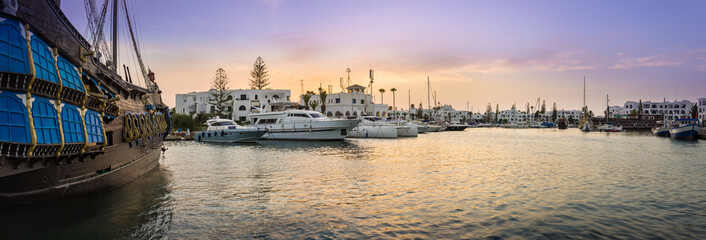 Panorama of amazing marina in Port El Kantaoui, Tunisia, colorful sunset sky and sea and beautiful yachts and white villas and hotels