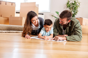 Happy family if three moving in the new apartment