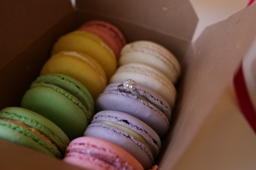 colorful macaroons with wedding band inside for proposal