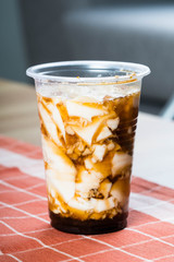 a cup of silken soy milk with muscuvado sugar and sago also known as taho