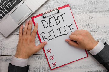 Handwriting text writing Debt Relief. Conceptual photo partial or total remission of it especially...