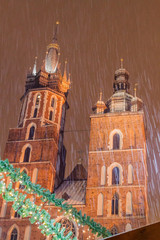 Night snowy view of St. Mary's Basilica at the medieval square Rynek Glowny in Krakow, Poland