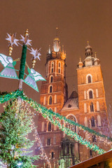 Night snowy view of St. Mary's Basilica at the medieval square Rynek Glowny in Krakow, Poland