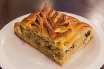 Piece of  Pirozhki (pirog) pie in a restaurant in Minsk, Belarus