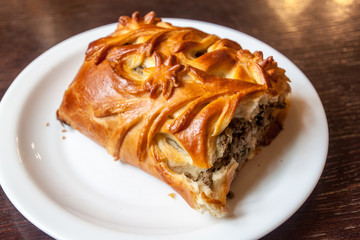 Piece of  Pirozhki (pirog) pie in a restaurant in Minsk, Belarus