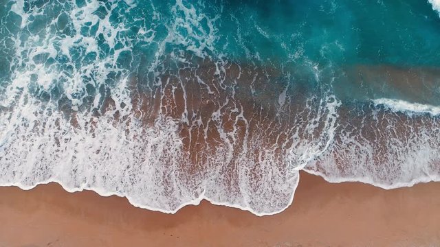 Aerial view of waves in a beach.
