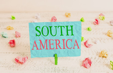 Word writing text South America. Business photo showcasing Continent in Western Hemisphere Latinos known for Carnivals Green clothespin white wood background colored paper reminder office supply