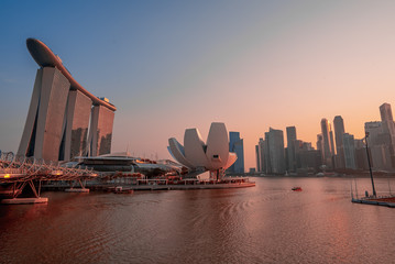 Marina Bay Sands with city buildings in a pink sunset. Wide angle