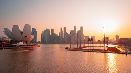 Marina Bay of Singapore sunset. Buildings in the background with a gentle pink sunset