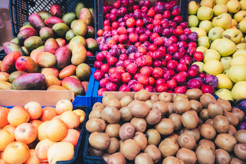 Street stall selling tropical fruits, faded colors.