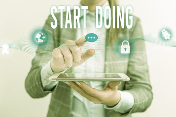 Handwriting text Start Doing. Conceptual photo asking someone to go with action right now dont hesitate Female human wear formal work suit presenting presentation use smart device