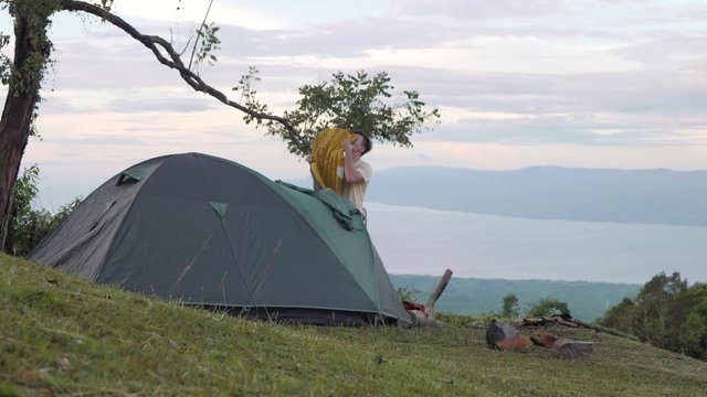 A man trying to put air in the camping airbed by blowing it with his mouth.