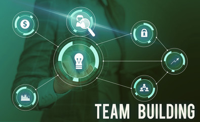 Conceptual hand writing showing Team Building. Concept meaning Types of activities used to enhance social relations Woman wear work suit presenting presentation smart device