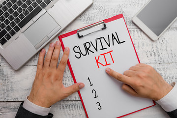 Writing note showing Survival Kit. Business concept for Emergency Equipment Collection of items to help someone