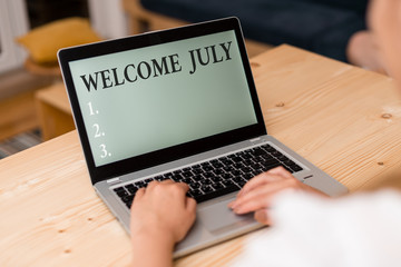 Word writing text Welcome July. Business photo showcasing Calendar Seventh Month 31days Third Quarter New Season woman laptop computer smartphone mug office supplies technological devices