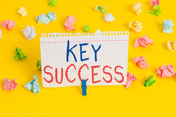 Word writing text Key Success. Business photo showcasing generally three to five areas that company may focus on Colored crumpled papers empty reminder white floor background clothespin