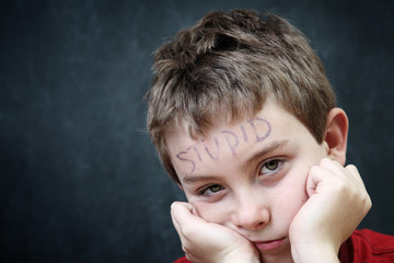 Student with stupid written on his forehead