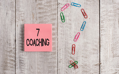 Writing note showing 7 Coaching. Business concept for Refers to a number of figures regarding business to be succesful Pastel colour note paper placed next to stationary above wooden table