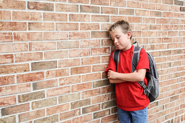 Depressed upset student standing outside school