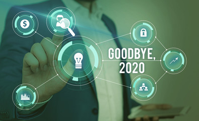 Word writing text Goodbye 2020. Business photo showcasing New Year Eve Milestone Last Month Celebration Transition Male human wear formal work suit presenting presentation using smart device