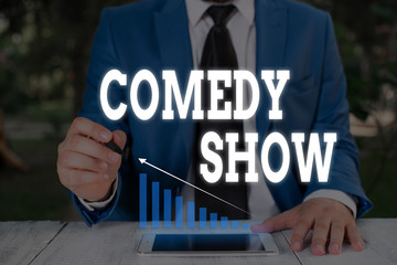 Handwriting text writing Comedy Show. Conceptual photo Funny program Humorous Amusing medium of Entertainment Male human wear formal work suit presenting presentation using smart device