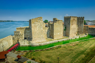 Fototapeta na wymiar Aerial view of Smederevo castle and moat with green water along the Danube river in Serbia former Yugoslavia with partially restored leaning towers