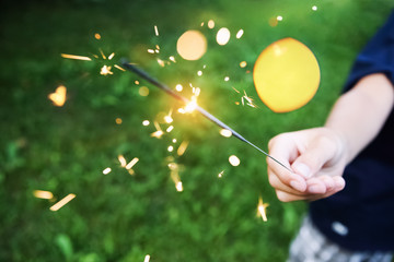 Child holding a sparkler