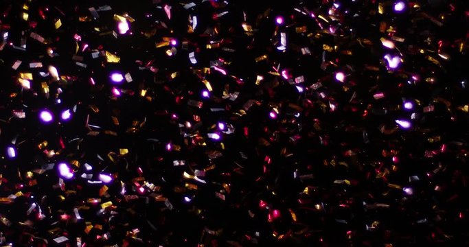Confetti fired in the air during a party. Only confetti on black background of the night. Falling metallic glitter foil confetti multicolor in black background.